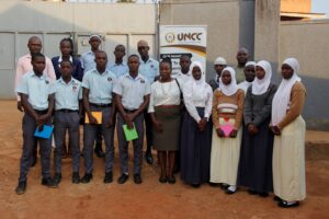 Mrs. Maureen Mutoni poses with debaters from Mamtaz Secondary school and Central college Kawala 